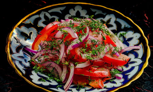 Tomato and onion salad Achik-Chuchuk with pilaf